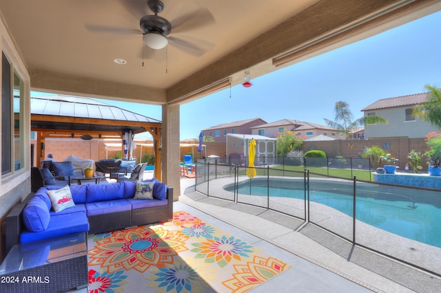 view of pool featuring outdoor lounge area, a gazebo, a patio, and ceiling fan