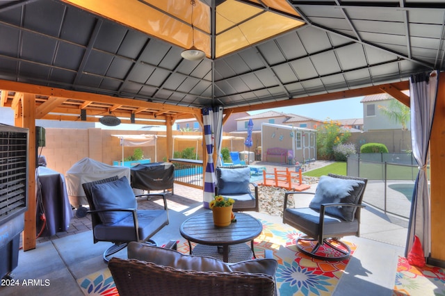 view of patio with a gazebo, an outdoor living space, and a pool