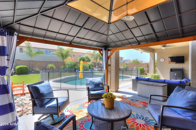 view of patio with a gazebo, ceiling fan, and a fenced in pool