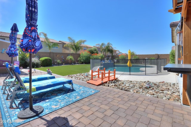 view of pool featuring a yard and a patio