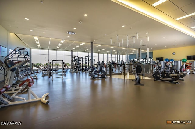 gym with a wall of windows