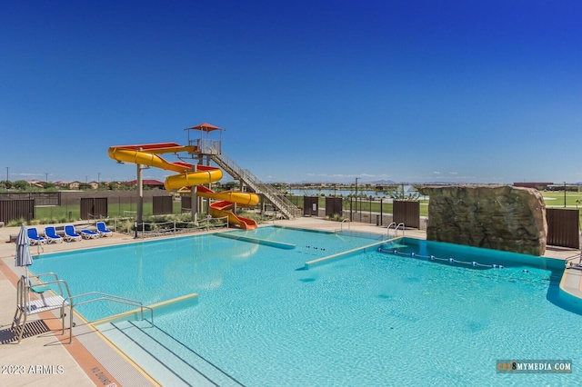 view of pool with a patio area and a water slide