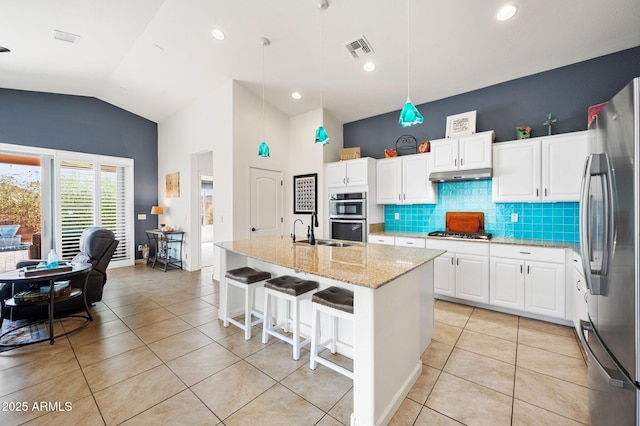kitchen with visible vents, under cabinet range hood, appliances with stainless steel finishes, and light tile patterned floors