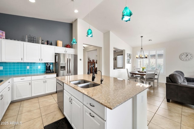 kitchen featuring an inviting chandelier, light tile patterned floors, a sink, and appliances with stainless steel finishes