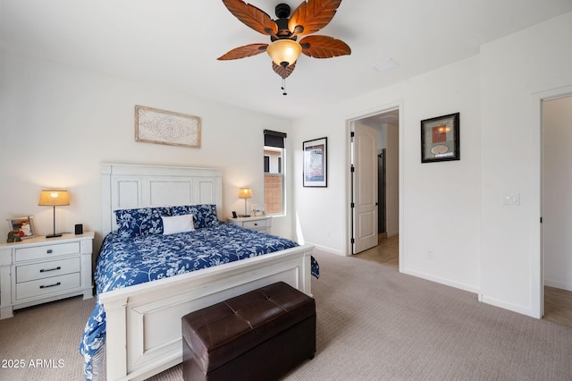 bedroom featuring light colored carpet, baseboards, and a ceiling fan