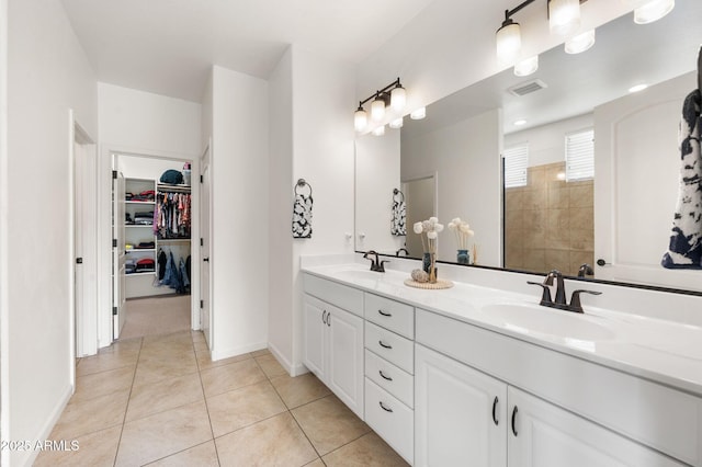 full bath featuring visible vents, a sink, tile patterned flooring, and double vanity
