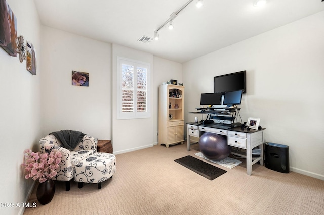 home office with baseboards, visible vents, rail lighting, and carpet