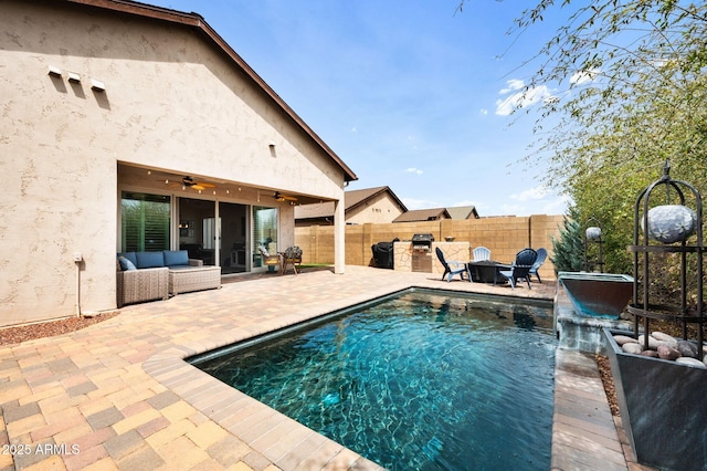 view of swimming pool featuring a patio, a fenced in pool, a fenced backyard, and a ceiling fan