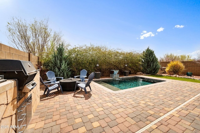 view of pool with a fenced backyard, area for grilling, and a patio