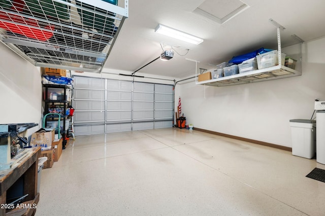 garage with baseboards and a garage door opener