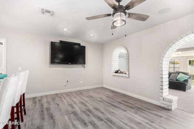 living room with ceiling fan and light wood-type flooring