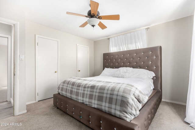 bedroom featuring ceiling fan and light carpet