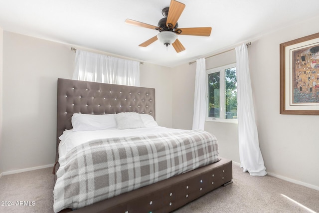 bedroom with ceiling fan and light carpet