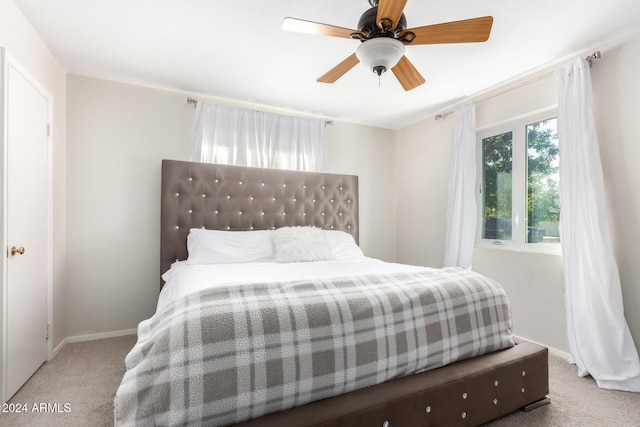 bedroom with ceiling fan and light carpet