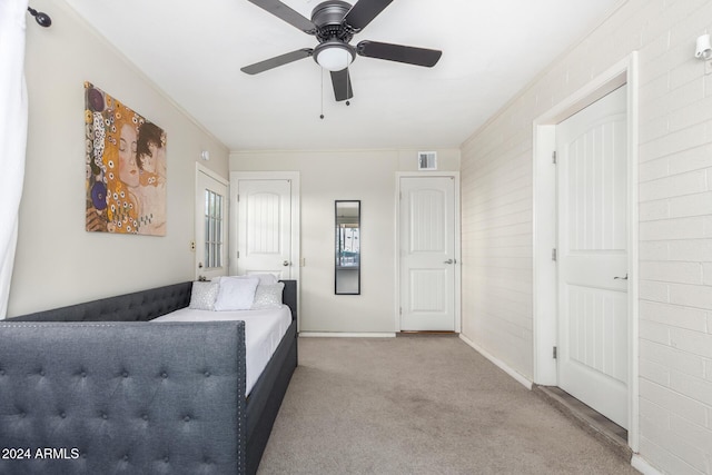 bedroom with light colored carpet, ceiling fan, and crown molding