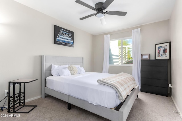 bedroom featuring light carpet and ceiling fan