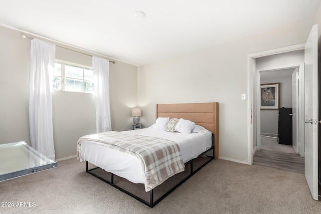 bedroom featuring light carpet