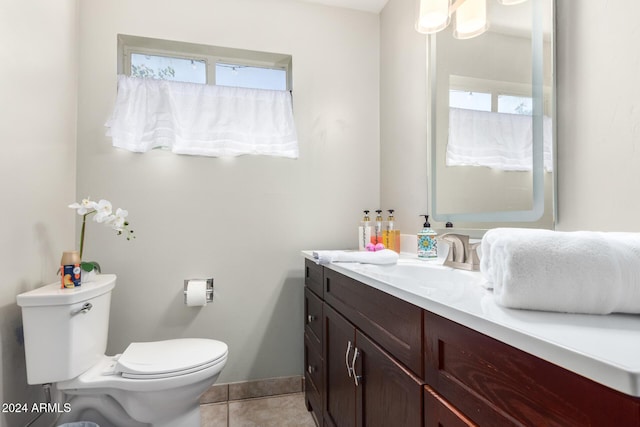 bathroom featuring tile patterned flooring, vanity, and toilet