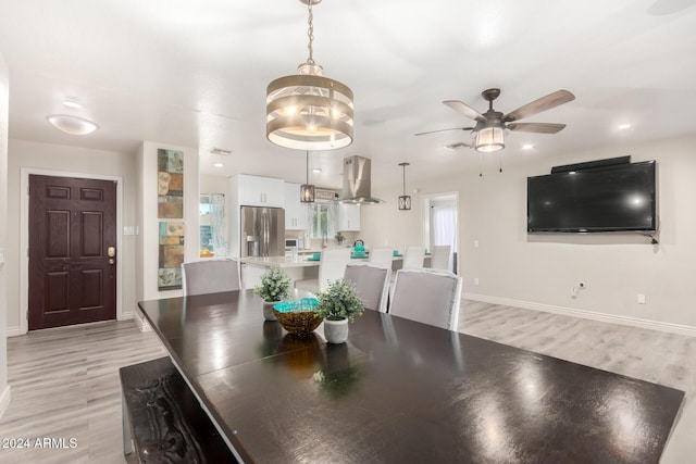 dining space featuring ceiling fan and light hardwood / wood-style flooring