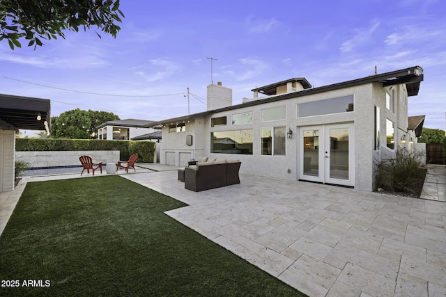 back of house with a patio, french doors, stucco siding, and a chimney
