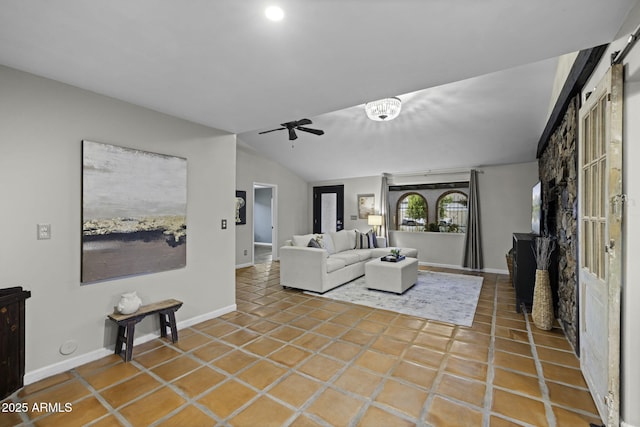 living room featuring ceiling fan, baseboards, lofted ceiling, and tile patterned floors