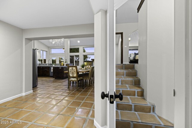 entrance foyer with baseboards and light tile patterned floors