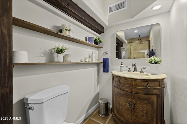 bathroom with vanity, toilet, and tile patterned floors