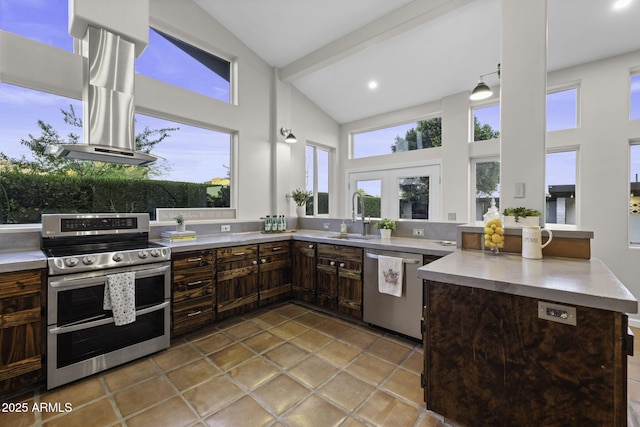 kitchen featuring appliances with stainless steel finishes, a sink, high vaulted ceiling, light countertops, and a peninsula