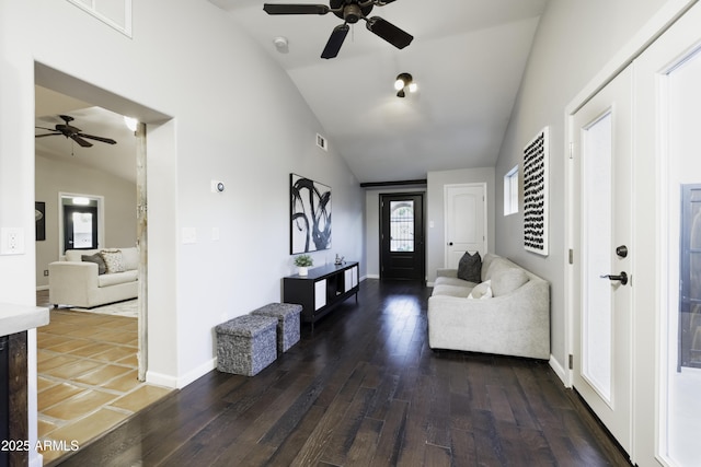 foyer with ceiling fan, lofted ceiling, hardwood / wood-style floors, and baseboards