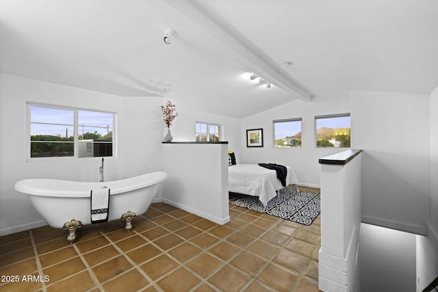 full bath with a soaking tub, baseboards, and tile patterned flooring