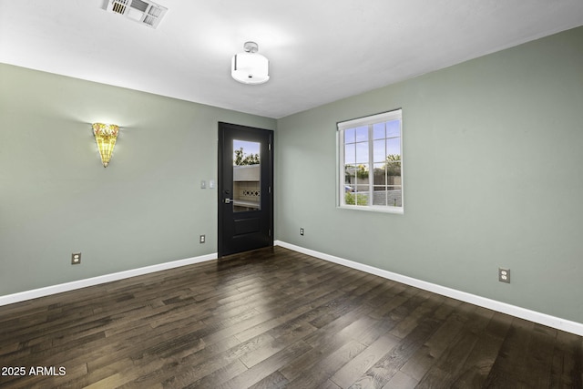 empty room with wood finished floors and baseboards