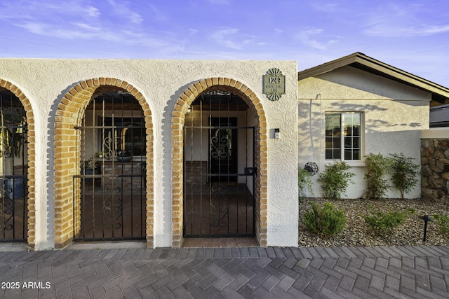 doorway to property with stucco siding