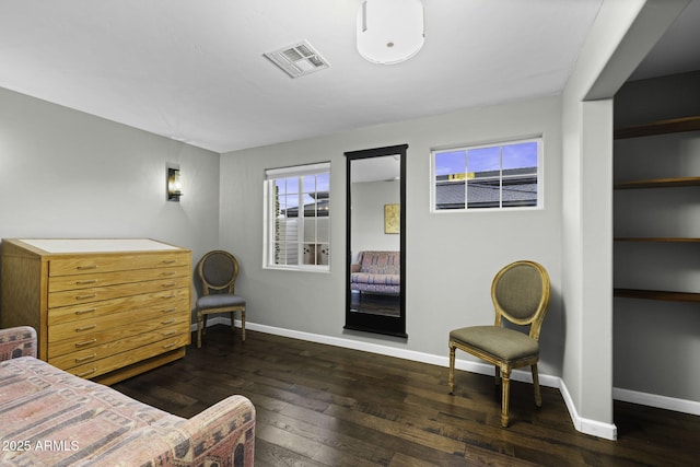 bedroom with wood-type flooring and baseboards