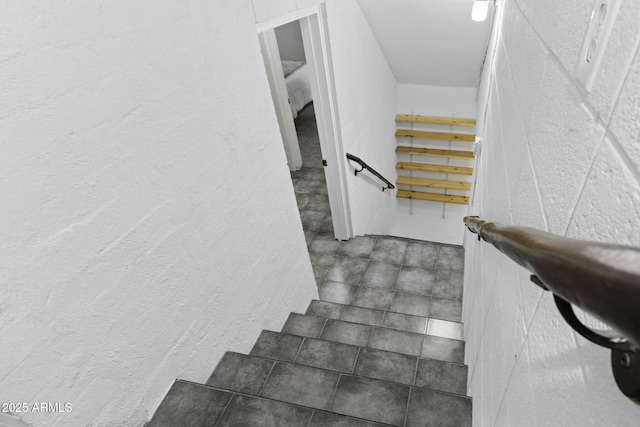 stairway with a textured wall