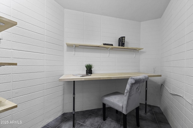 office area featuring dark tile patterned flooring