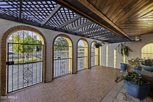 view of patio with a pergola and a gate