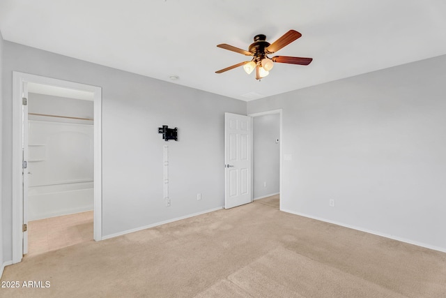 8071 W Georgetown Way, Florence, AZ 85132 - unfurnished bedroom featuring light carpet, baseboards, a walk in closet, a closet, and ceiling fan