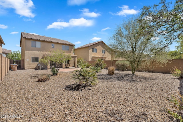 8071 W Georgetown Way, Florence, AZ 85132 - rear view of house featuring stucco siding, a fenced backyard, a patio area, and a tiled roof