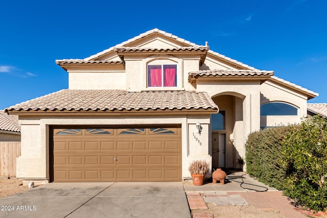 mediterranean / spanish-style house with a garage