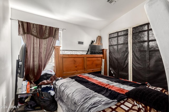 bedroom featuring vaulted ceiling