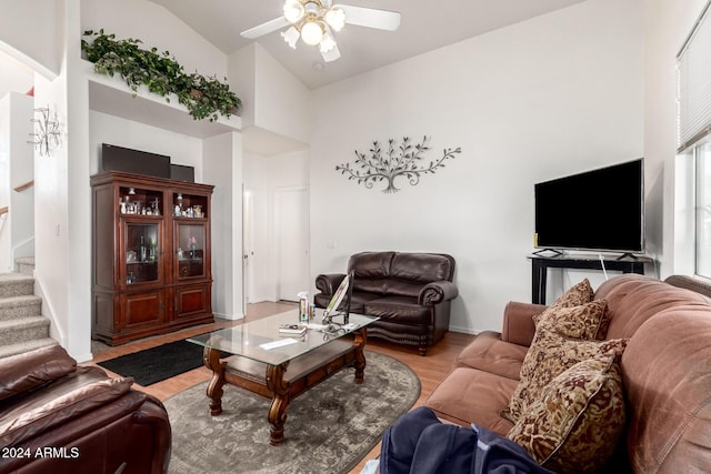 living room featuring wood-type flooring, high vaulted ceiling, and ceiling fan