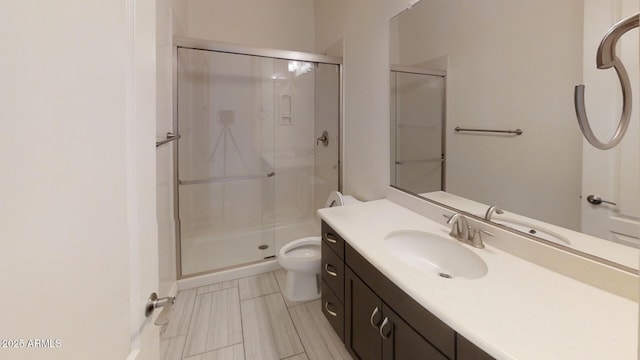 full bathroom with a shower stall, toilet, and vanity