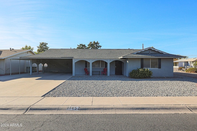 single story home featuring a carport