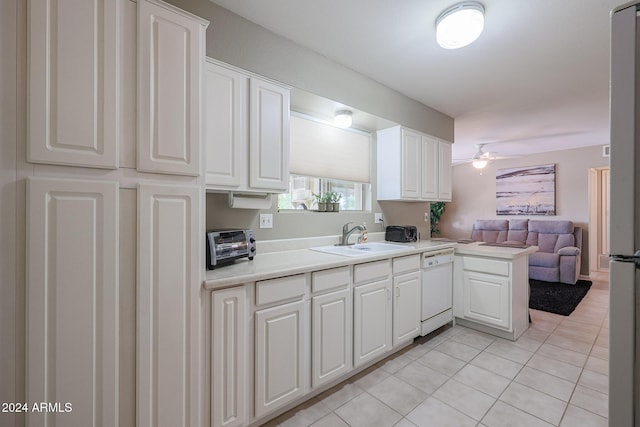 kitchen with kitchen peninsula, white cabinetry, sink, and dishwasher