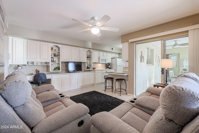 living room featuring ceiling fan and light tile patterned flooring