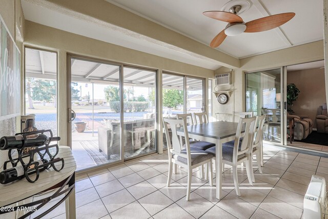 dining room featuring a wall unit AC, ceiling fan, and light tile patterned flooring