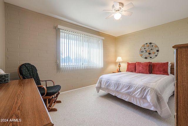 bedroom with carpet floors, ceiling fan, and brick wall