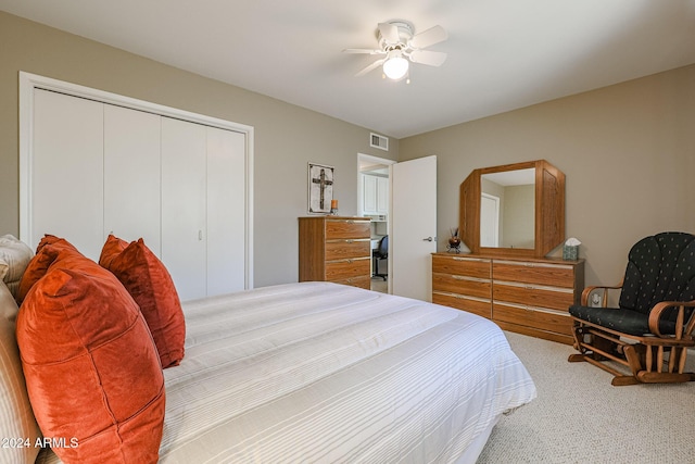 carpeted bedroom with ceiling fan and a closet