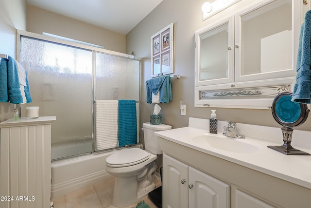 full bathroom featuring tile patterned flooring, vanity, toilet, and enclosed tub / shower combo