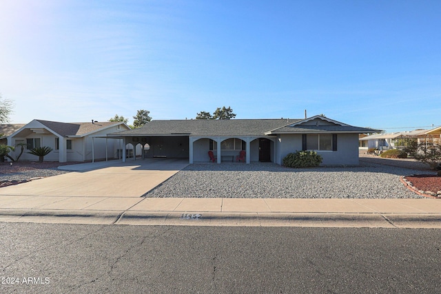 ranch-style house featuring a carport